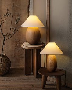 two wooden lamps sitting next to each other on a table