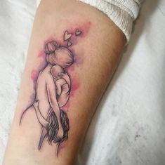 a woman's arm with a tattoo on it that has an image of two people hugging