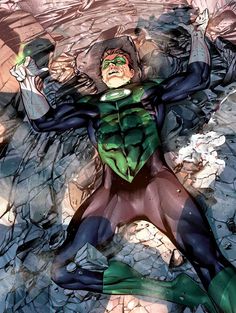 the green lantern is laying on his back in front of rocks and water with his arms outstretched