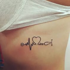 a woman with a heartbeat tattoo on her stomach