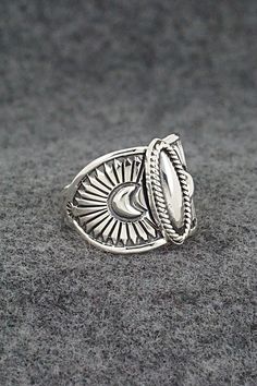 This finely crafted sterling silver ring was made by Navajo silversmith Derrick Gordon. The back is signed Derrick and stamped sterling.Size: 9.5Length: 5/8"Free shipping on all orders! We ship with USPS and always include tracking. All orders ship within a day of payment.Returns are accepted up to 30 days after you receive your order. Just send us a message. Our shop offers cash back or store credit. The item must be returned in new condition. Silver Bohemian Concho Rings, Bohemian Silver Concho Rings, Handmade Silver Western Style Rings, Handmade Western Silver Rings, Bohemian Silver Rings With Polished Finish, Western Sterling Silver Concho Rings, Western Style Sterling Silver Concho Rings, Western Style Sterling Silver Rings In Silver, Western Style Sterling Silver Rings