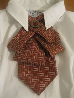 a close up of a tie on a white shirt