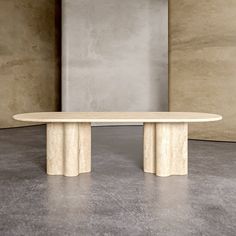 a round table sitting in front of a wall with concrete columns on it's sides