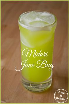 a green drink sitting on top of a wooden table