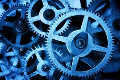 close up view of several gears in the shape of an abstract clock face, blue tone