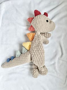 a crocheted stuffed animal laying on top of a bed