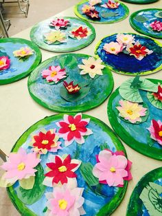 paper plates with water lilies on them sitting on a table