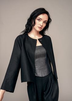 Both black and linen are unexpected choices for a jacket, but the IRA LYSA Barbera Jacket will become your go-to for unexpected spring and summer nights. Sleeves rolled up or down, buttoned or unbuttoned, belted or not - the choice is yours. * A-line jacket* Pockets* One decorative snap* Round neckline* Raglan sleeves* Cropped sleeves Material: 100% European linen, silk lining Handmade. Always. Chic Tailored Linen Outerwear, Tailored Linen Outerwear For Spring, Black Linen Outerwear For Fall, Black Single Breasted Cropped Jacket For Spring, Black Single-breasted Cropped Jacket For Spring, Chic Business Casual Summer Outerwear, Chic Summer Business Casual Outerwear, Chic Summer Outerwear For Business Casual, Chic Linen Outerwear For Fall