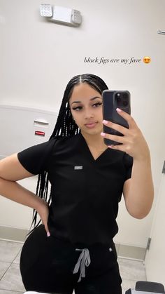 a woman taking a selfie in the bathroom with her cell phone up to her ear