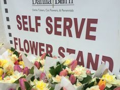 there is a sign that says self serve flower stand