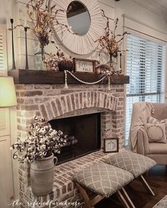 a living room filled with furniture and a fire place in front of a brick fireplace