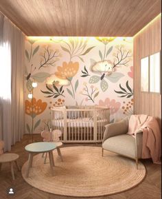 a baby's room decorated in pastel colors with flowers on the wall and round rug