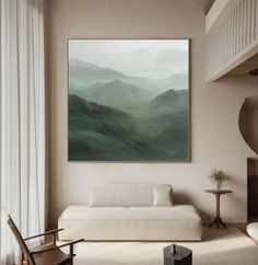 a living room filled with furniture and a painting hanging on the wall over a white couch