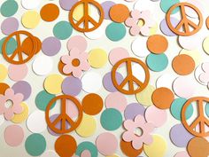 there are many peace signs on the wall with polka dot circles around them and flowers