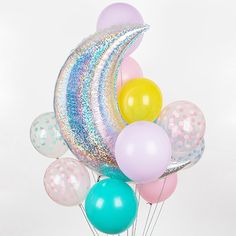 a bunch of balloons that are sitting on top of each other in front of a tweet