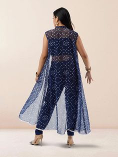 Step out in style with our Vibrant Verve Blue Bandhani Chiffon three Piece Suit. This elegant Indo Western ensemble features a beautiful blue Bandhani design on flowing chiffon fabric, exuding a perfect blend of traditional and contemporary charm. The three-piece suit includes a top, bottom, and dupatta, offering versatility and sophistication for various occasions. Care Instructions: Dry clean recommended to maintain the fabric's quality and colors. Sleeveless Georgette Dress For Eid, Blue Sleeveless Silk Chiffon Dress, Blue Fitted Chiffon Sets, Blue Chiffon Party Sets, Blue Bollywood Georgette Dress, Blue Chiffon Sets With Sheer Dupatta, Blue Georgette Dress With Traditional Drape, Blue Georgette Dress For Navratri, Sheer Georgette Dress For Eid