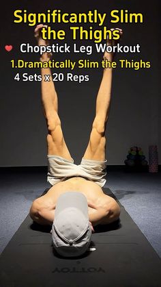 a man doing a back stretch on top of a yoga mat with his hands in the air