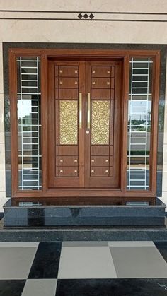 the front door to a building with two glass doors and black and white checkered flooring