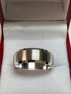 a silver ring sitting in a red box