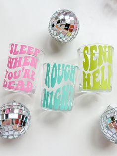 four disco balls with words on them sitting next to each other