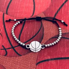 a white beaded bracelet with a basketball on it