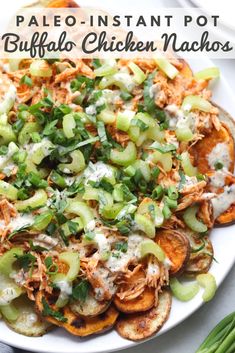 a white plate topped with baked potato wedges covered in buffalo chicken nachos