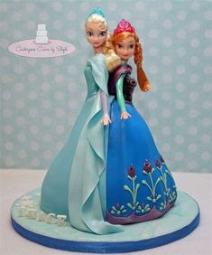 there is a cake that has two dolls on it and one is holding the other