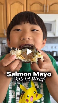 a young boy eating a piece of food with the caption salmon mayo on it