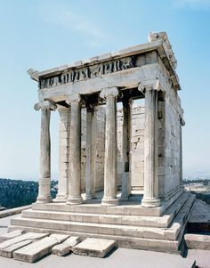 an old building with some columns on it