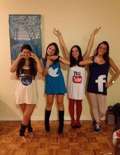 four girls are posing for the camera with their arms in the air