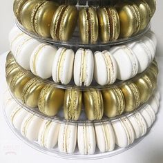 three tiered tray with gold and white macaroons