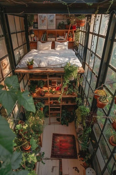 an indoor bedroom with lots of plants in the windows and on the floor, there is a bed surrounded by potted plants