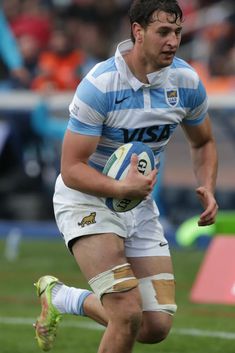 a rugby player is running with the ball