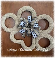 a wreath made out of rope with dog paws and bows on the front door