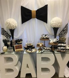 a baby shower table with black and white decorations