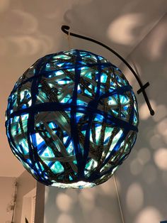 a blue light fixture hanging from the ceiling