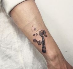 a person with a tattoo on their arm has a magnifying glass in it