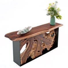 a vase with flowers on top of a wooden bench that is made out of wood