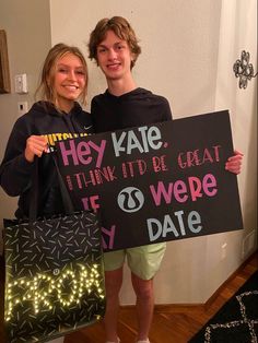 two people holding up signs that read hey kate think it's great to be wed date