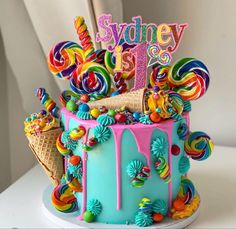 a birthday cake decorated with candy and lollipops