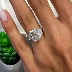 a woman's hand with a diamond ring on it