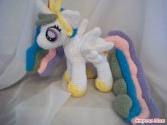 a crocheted stuffed toy with a rainbow on it