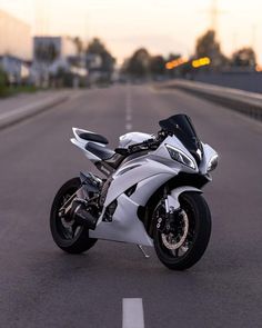 a white motorcycle is parked on the street