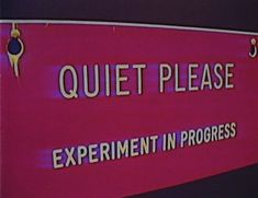 a sign that says quiet please experiment in progress