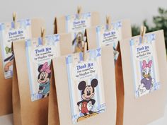 small brown bags with mickey mouse tags on them