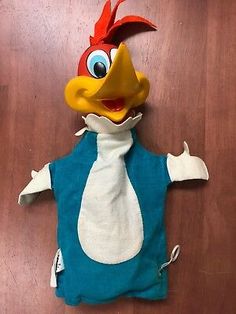 a stuffed animal that is wearing a blue shirt and tie with an angry bird on it's head