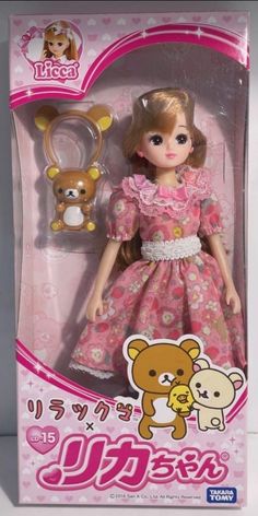 a doll in a pink dress and bear keychain