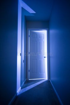 an open door in a dark room with blue light coming from the top and bottom