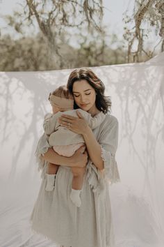 a woman holding a baby in her arms