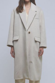 This oversized long coat is made with a heavyweight material to keep you warm and features a tortoise swirl button. The style is completed with a large lapel collar and drop shoulders. Oversized fit Drop shoulder Long sleeves Large notch lapel Lined front pockets Single button closure Features tortoise swirl button Midi length Lined Hand wash cold Do not bleach Do not tumble dry Iron low Shell: 100% Polyester Lining: 100% Polyester JJ1813J Total length: 44.50" Bust: 48" S BEIGE, CAMEL: Height 5' Beige Long Wool Coat With Button Closure, Formal Single-breasted Beige Wool Coat, Beige Single-breasted Wool Coat, Elegant Beige Double-breasted Wool Coat, Beige Long-sleeve Wool Coat With Pockets, Chunky Sweater, Winter Day, Long Coat, Drop Shoulder